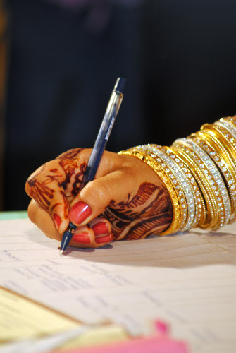 Indian bride signing marriage license signature